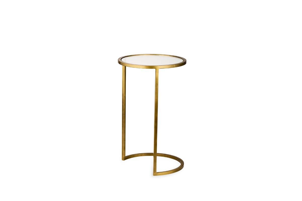 The Nakuru Iron & Glass Side Table Set by nkuku features a modern brass design with a round white glass top and slim gold frame. Its open C-shaped base adds minimalist style, making it perfect for chic living spaces.