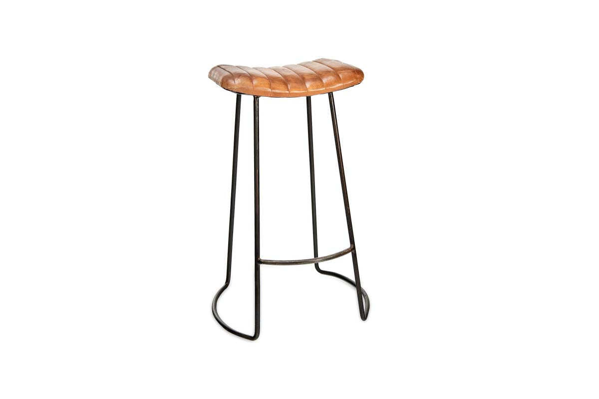 The Narwana Ribbed Leather Stool - Aged Tan (Large) by nkuku features a modern ribbed leather saddle seat, slender black metal legs with footrest, and subtly curved base supports, shown against a plain white background.
