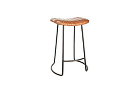The nkuku Narwana Ribbed Leather Stool in Aged Tan (Small) features a padded tufted seat, distressed brown ribbed leather, and slim black metal legs, shown against a white background.