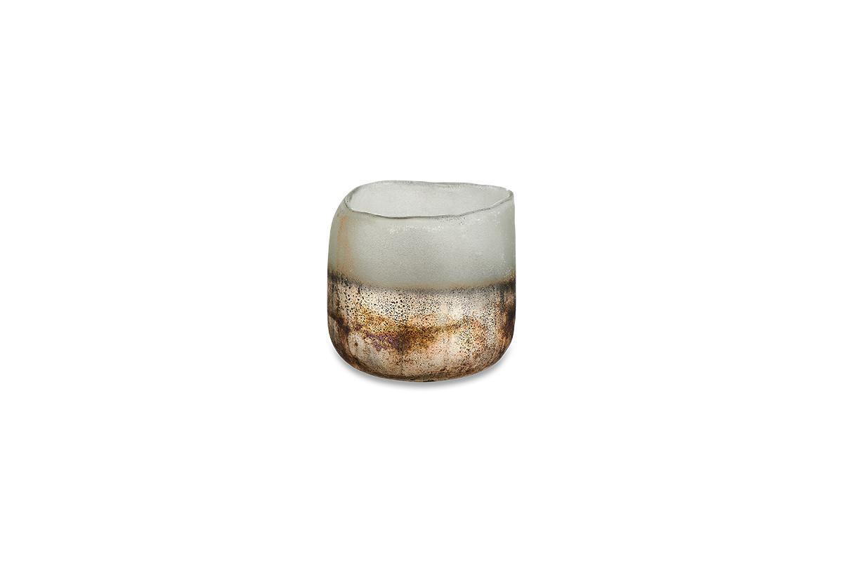 The Ngolo Tealight Holder - Aged Smoke by nkuku is a small, round recycled glass tumbler with an uneven rim. Its frosted white upper half fades into a mottled brown and beige, perfect for creating atmosphere on a plain background.