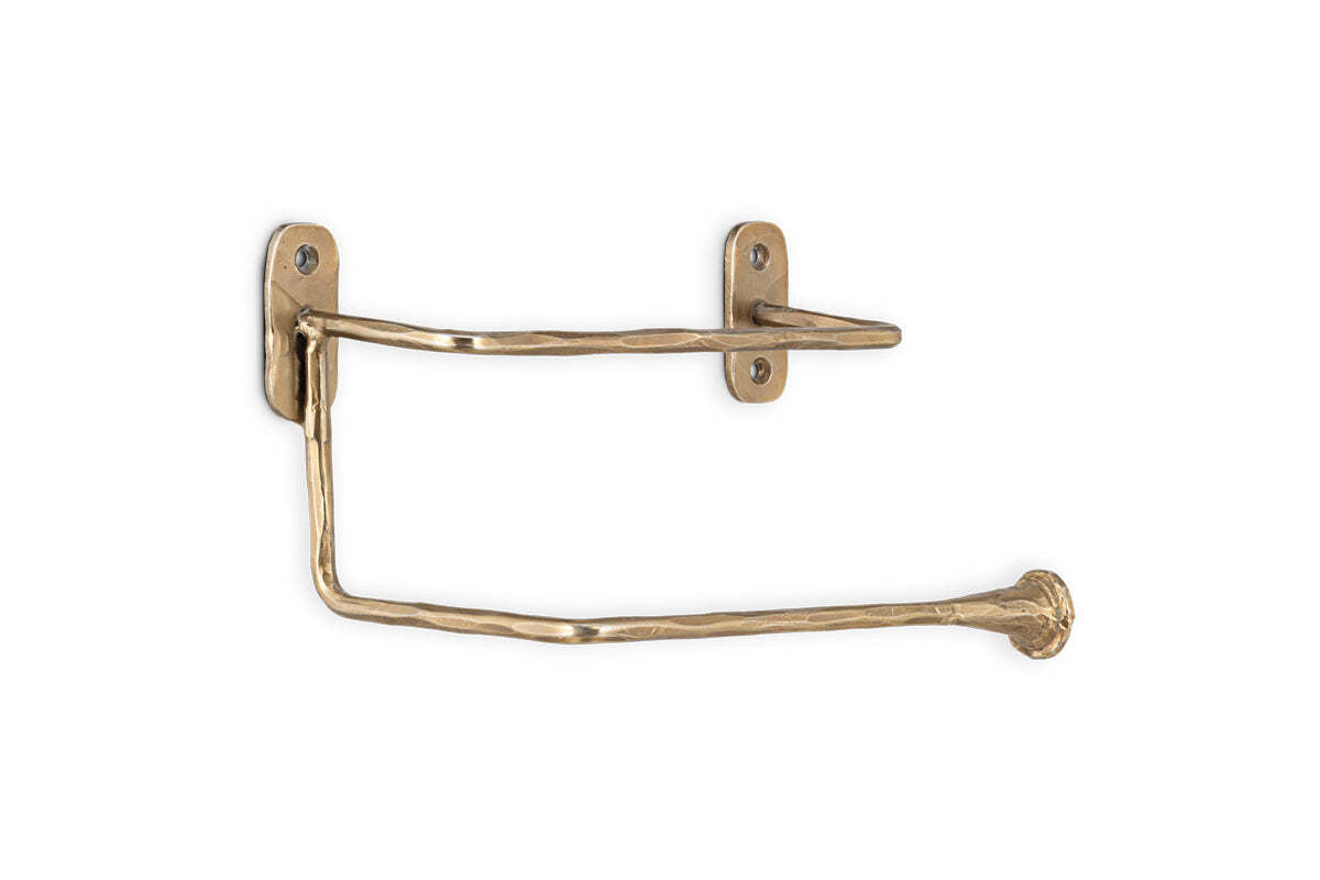 The Olani Toilet Roll Holder by nkuku features antique brass with a textured, handcrafted finish, two mounting plates, and a flared-tip horizontal arm to hold your toilet roll securely. Perfect for adding elegance to any bathroom.