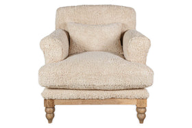 The nkuku Otas Teddy Cotton Armchair in off white features plush, textured fabric, thick rounded arms, a matching cushion, and four turned natural mango wood legs. The background is plain white.