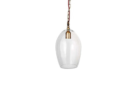 The nkuku Otoro Recycled Glass Pendant - Clear - Small Oval features an elongated clear shade, brass fittings, a brown cord, and hangs from a gold chain, creating an elegant look against a plain white background.