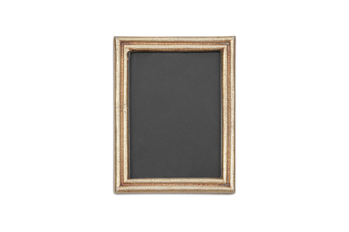 The nkuku Pambani Photo Frame features an antique brass frame and a black background.
