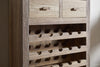 The nkuku Shanthi Reclaimed Wood Wine Rack - Natural features two top drawers and multiple horizontal slots for bottles, all crafted from natural, weathered wood for a rustic look.