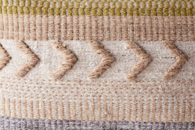 The Tuleeka Wool Cushion Cover - Ochre by nkuku features a textured woven design with beige, cream, brown, ochre, and olive stripes plus raised zigzag lines—ideal for adding stylish flair to any setting.