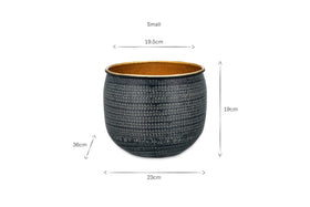 The nkuku Tembesi Etched Planter - Antique Black & Brass is a round pot with a grid-like white dotted pattern, wide opening, tan interior, and dimensions of 19.5 cm diameter (top), 19 cm height, 23 cm width. “Small” appears above the pot.