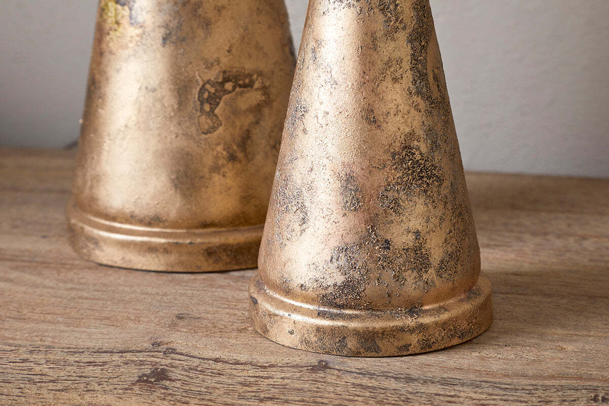 The Talna Tree Bell - Antique Brass by nkuku features a weathered, gold-toned finish with dark mottled spots, resembling an antique brass bell—ideal as a unique festive ornament or Christmas decor.