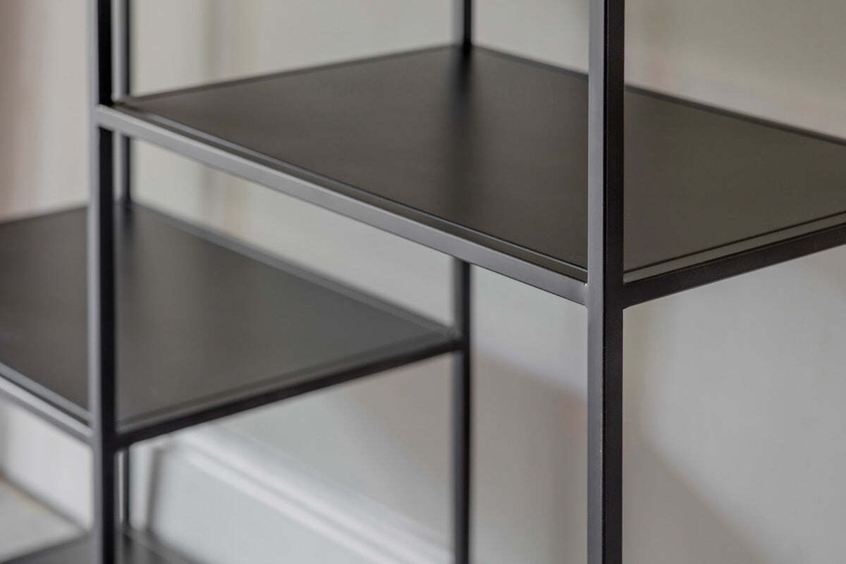 A close-up of the Tanvi Display Shelf - Black - Wide by nkuku, showcasing its modern black metal industrial design with two shelves and vertical support.