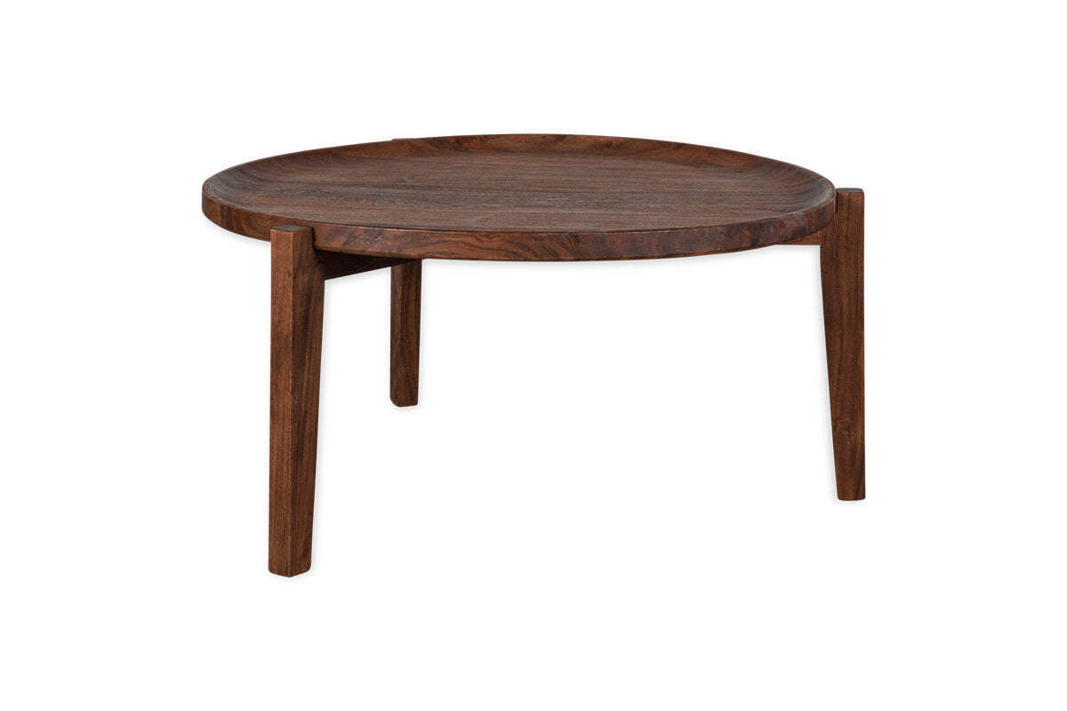 The nkuku Umar Mango Wood Coffee Table - Dark Brown features a sculptural, circular design with a curved surface and tapered legs, highlighting modern minimalism against a crisp white background.