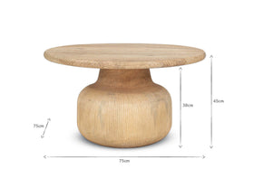 The nkuku Vivan Grooved Wood Coffee Table features a round, wide top and bulbous base in sustainable mango wood. Measuring 75cm wide by 45cm tall, it's a stylish contemporary centerpiece for modern living spaces.