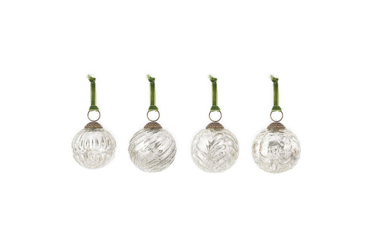 The nkuku Adoya Baubles - Aged Nickel (Set of 4) feature ribbed glass designs, each with a silver cap and green velvet tie, offering elegant festive decor against a plain white background.