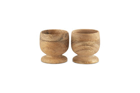 The nkuku Awa Wooden Egg Cup - Natural (Set of 2) features small, round wooden cups with a natural grain finish, perfect for adding classic style and warmth to your breakfast table.