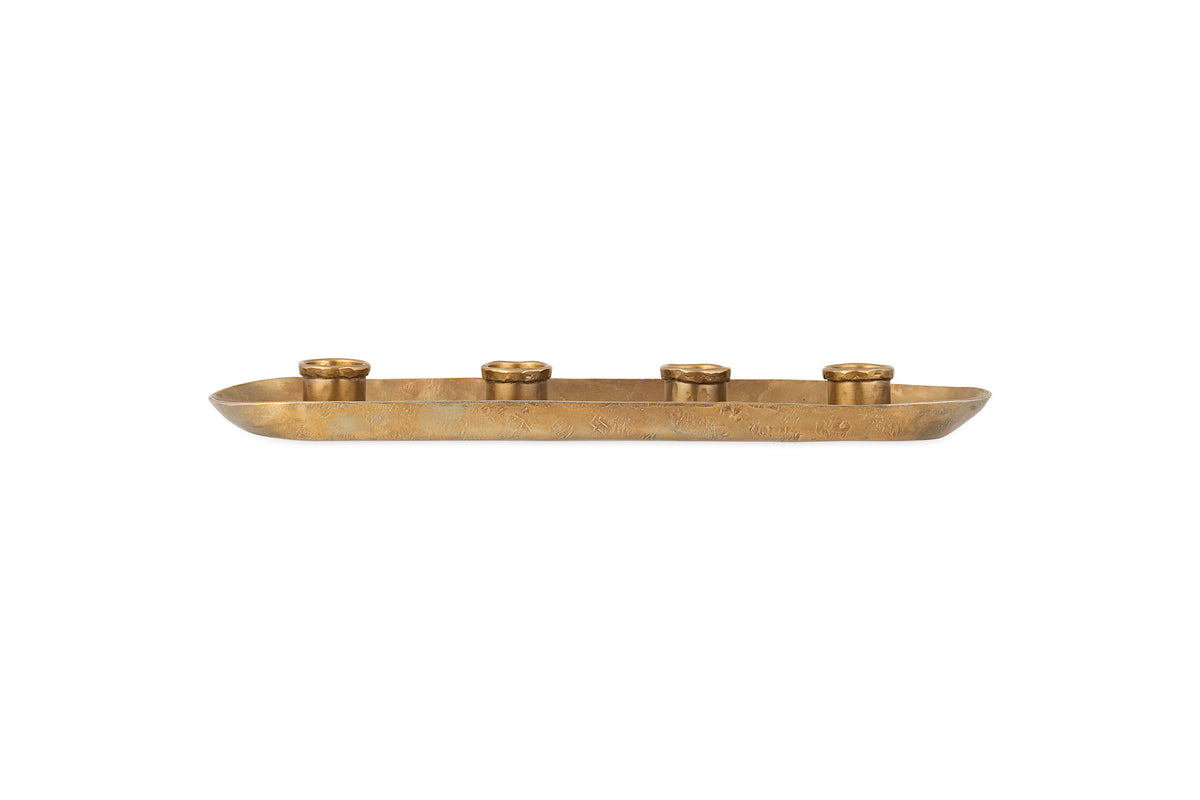 The nkuku Amita Long Candle Holder in antique brass features a shallow, rectangular shape with rounded corners, hammered texture, and four equally spaced holders—perfect as a stunning dining table centrepiece.