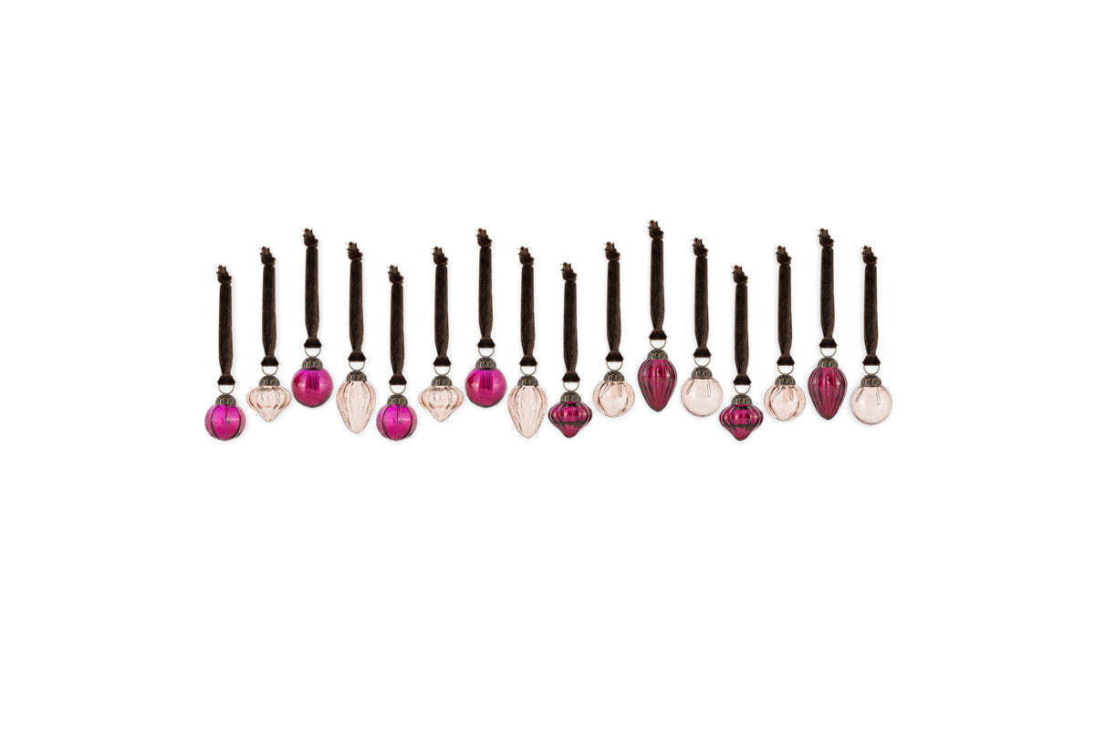 A set of 16 Adisa Bauble Jar ornaments by nkuku in ruby and copper tones features mini glass baubles with dark strings and black beads, creating vibrant festive decor that stands out against a plain white background.