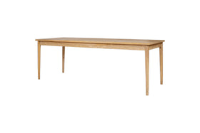The Anbu Mango Dining Table - Natural by nkuku features a simple rectangular design with four straight legs and a light natural mango wood finish, shown against a white background. It brings subtle elegance to any space and complements the Anbu collection.