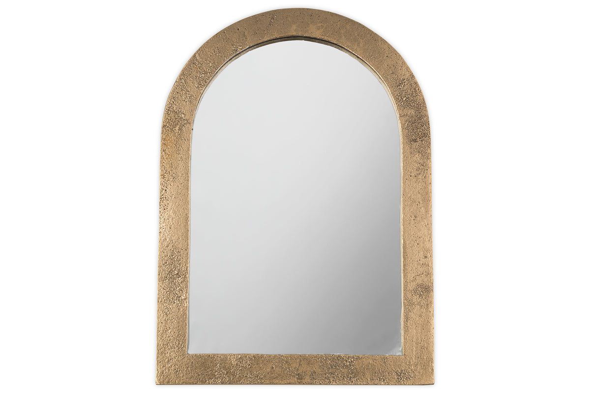 The Cayce Cast Aluminum Vanity Mirror by nkuku features an arched design with a wide, textured antique brass frame, shown against a white background.