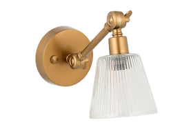 The Davika Ribbed Glass Task Wall Lamp by nkuku features a round base, adjustable angled arm, and clear ribbed glass shade in antique brass, giving any room a timeless look that stands out against white walls.