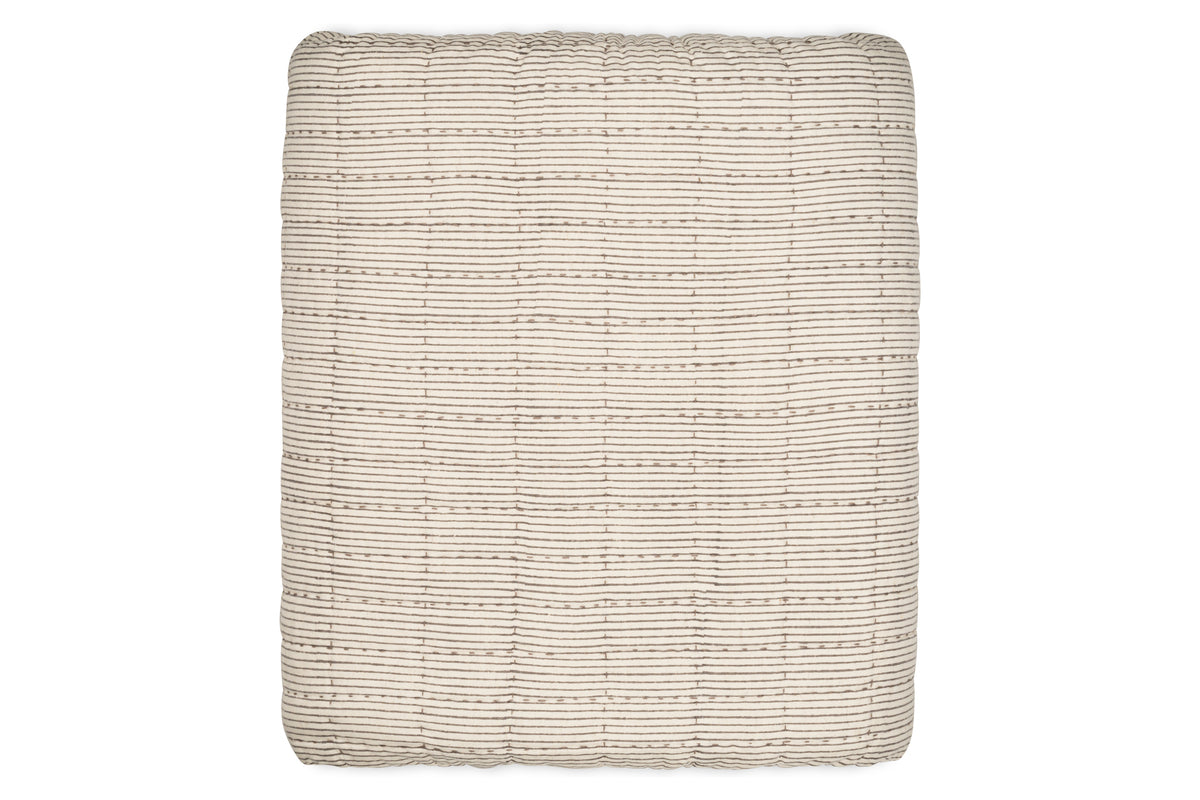 The nkuku Dipti Cotton & Linen Block Print Bed Quilt in Charcoal features a minimalist grid pattern, blending soft, textured cotton and linen. Perfect as a King size quilt for a modern bedroom.