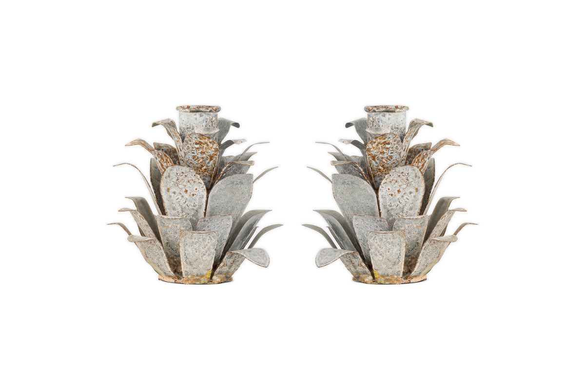 The nkuku Elagalu Pine Cone Candle Holders (Set of 2) are crafted from zinc with layered, spiky details and a rustic finish—stylish festive accents or unique Christmas candleholders for your tabletop.