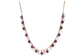 The Ekiti Bauble Garland - Ruby & Copper by nkuku features a fine gold chain with alternating ruby and copper gemstone pendants in square and teardrop shapes, inspired by vintage decor and the classic Ekiti bauble garland.