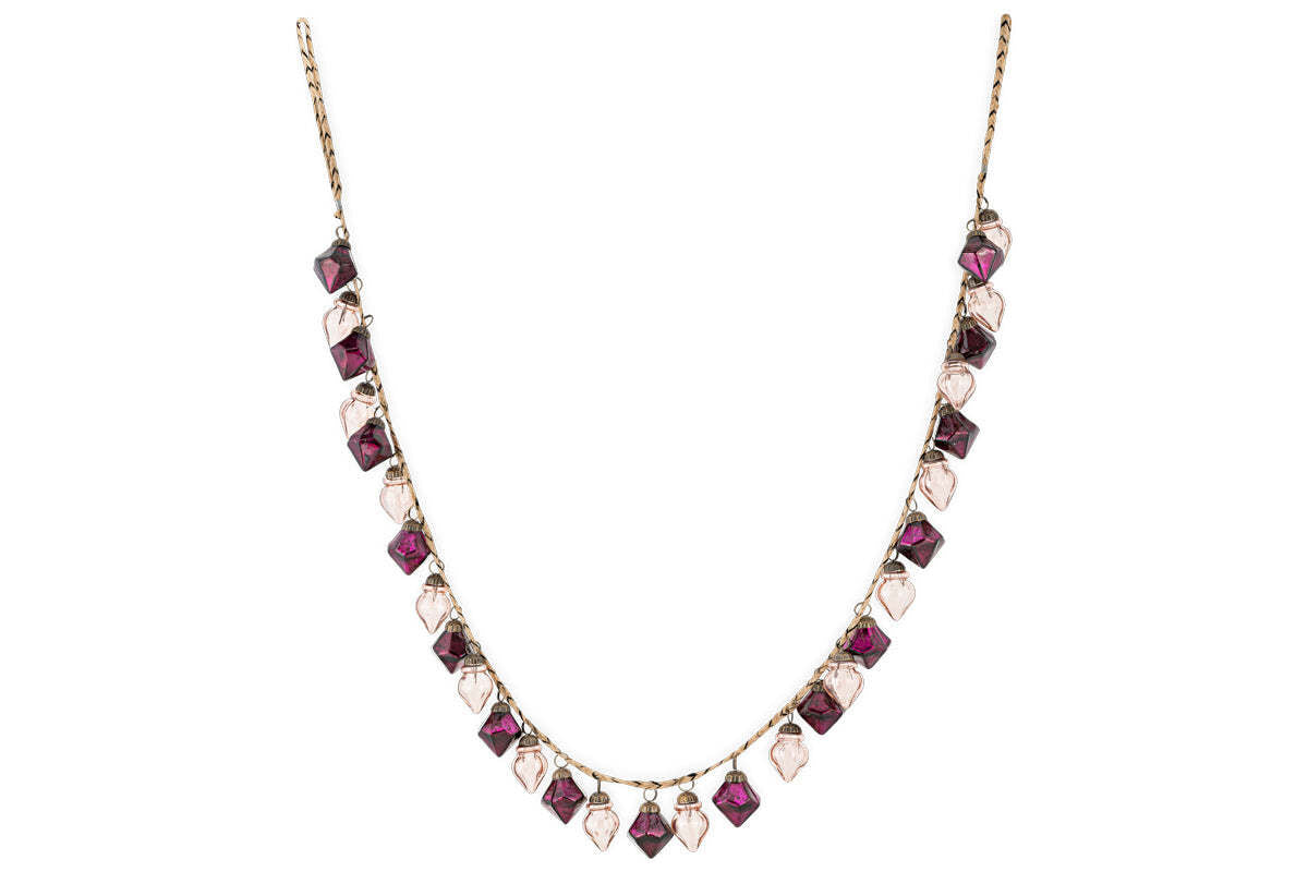 The Ekiti Bauble Garland - Ruby & Copper by nkuku features a fine gold chain with alternating ruby and copper gemstone pendants in square and teardrop shapes, inspired by vintage decor and the classic Ekiti bauble garland.