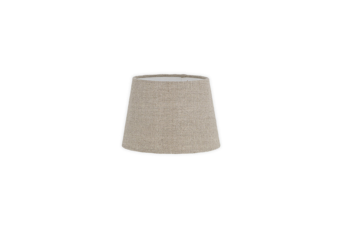 The Embaata Linen Lampshade - Natural by nkuku features a beige textured linen in a simple, tapered cylindrical design, shot against a white background—perfect for adding cozy bedroom lighting.