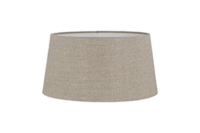 The Embaata Linen Lampshade - Natural by nkuku features a slightly tapered cylindrical shape and subtle textured linen finish in beige, shown against a white background.