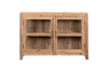 The nkuku Ibo Reclaimed Wood & Glass Sideboard - Natural features a rectangular, rustic design with two glass-paneled doors, antique brass handles, short legs, and a natural wood finish.