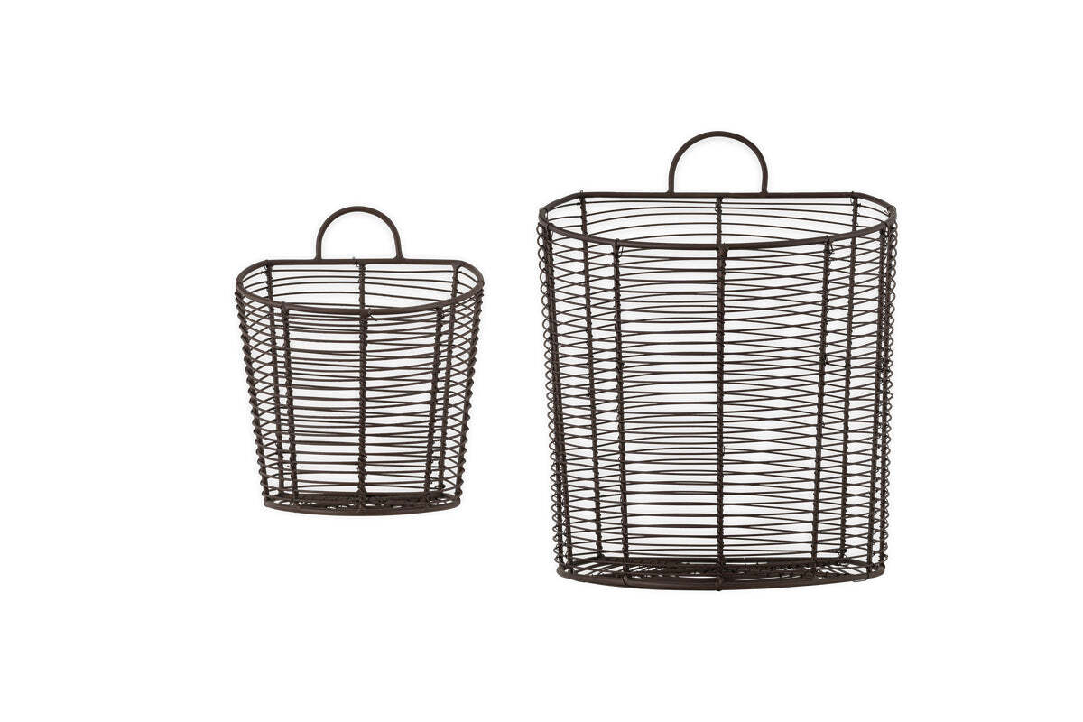 The nkuku Inkollu Wall Hung Baskets in aged brass are shown side by side against a white background, with the smaller basket to the left of the larger one. Each features a handle at the top, ideal for pantry storage. Set includes two baskets.