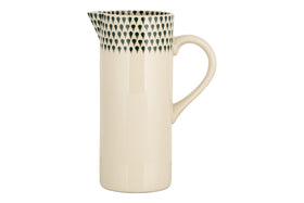 The nkuku Juniper Drop Jug - Cream & Juniper - Large features a tall, cream design with a curved handle and dark green teardrop accents—ideal as a water jug or decorative vase.