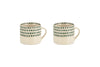 The nkuku Juniper Drop Mug - Cream & Juniper - Small (Set of 2) features two cream ceramic mugs with unique handles and juniper green drop details, displayed side by side on a white background.