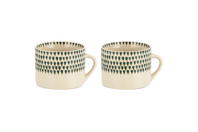 The nkuku Juniper Drop Mug - Cream & Juniper - Large (Set of 2) features two cream ceramic mugs with distinctive handles and a dark juniper green drop design near the rim, shown side by side on a white background.