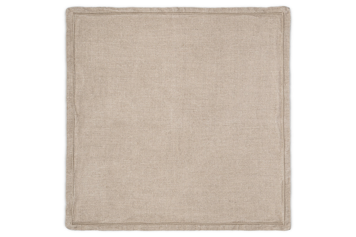 The nkuku Junto Linen Napkin - Natural (Set of 4) features rectangular beige napkins with stitched edges, offering a neutral touch to your table and lying flat against any surface.