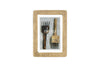 The Jahala Wall Hung Photo Frame by nkuku features an antique brass thick frame and displays two rustic metal tools on a light background, with “nkuku” centered in the image.
