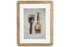 The Jahala Wall Hung Photo Frame in antique brass by nkuku showcases a photo of two vintage kitchen tools on a light surface. The text “nkuku, BEAUTIFULLY HANDMADE, HOME LIFESTYLE” is displayed.