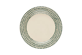 The nkuku Juniper Drop Dinnerware Set in cream and juniper features round ceramic plates with a cream center and a border of green teardrop patterns—perfect for stylish dining.