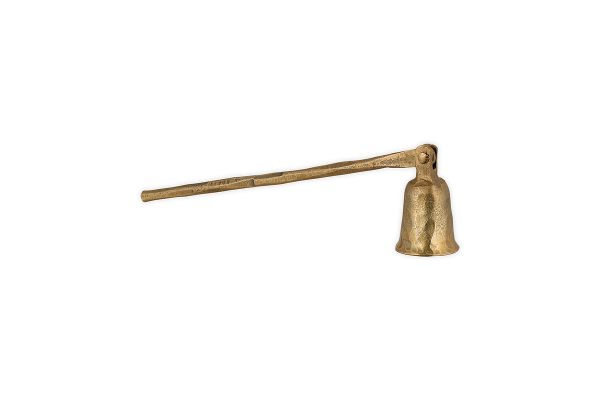 The nkuku Jyoti Candle Snuffer in antique brass features a long, textured handle and bell-shaped end—ideal for candle lovers—shown isolated on a white background.