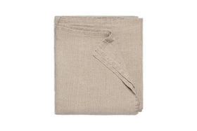 The nkuku Junto Linen Tablecloth in Natural (Small) is neatly folded and displayed against a plain white background.