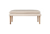 The Kiana Cotton Upholstered Bench by nkuku features a cushioned seat and wooden legs in a natural finish—an elegant accent piece for any room, shown against a white background.