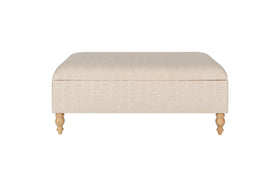 The Kiana Upholstered Storage Ottoman in Natural by nkuku, shown front-facing against a white background, features wooden legs and offers versatile storage and cushioned seating for your living space.