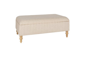 The Kiana Upholstered Storage Ottoman by nkuku features a natural beige finish, cushioned top, and four light wooden legs—perfect as a footrest or extra seating in your living space, shown here against a white background.