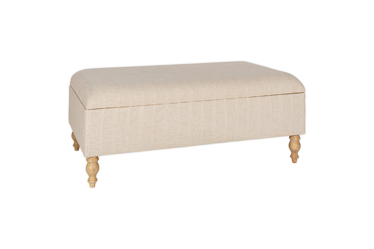 The Kiana Upholstered Storage Ottoman by nkuku features a natural beige finish, cushioned top, and four light wooden legs—perfect as a footrest or extra seating in your living space, shown here against a white background.