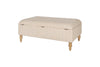 The Kiana Upholstered Storage Ottoman - Natural by nkuku features a beige fabric, hinged lid, and four light wooden legs, blending style and function for your living space. Shown against a white background.