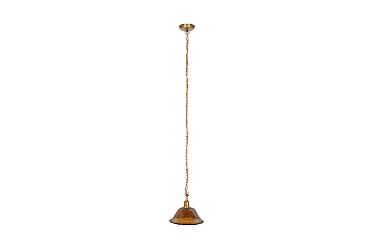 The nkuku Keju Organic Shape Recycled Glass Pendant in Dark Amber features a small brown glass shade, antique brass chain, and gold ceiling mount, shown here suspended against a white background.
