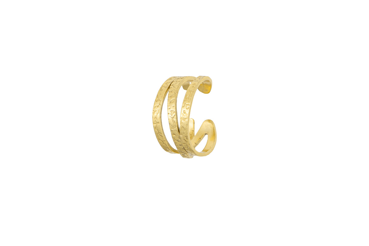The Katai Ring - Gold by nkuku features three parallel, hammered texture bands with a subtle engraved pattern, displayed against a plain white background.
