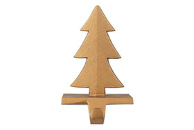The nkuku Kotta Stocking Tree Holder in antique brass features a stylized Christmas tree design with three layered branches and a rectangular base, making it a festive and elegant way to hang stockings on your mantel.