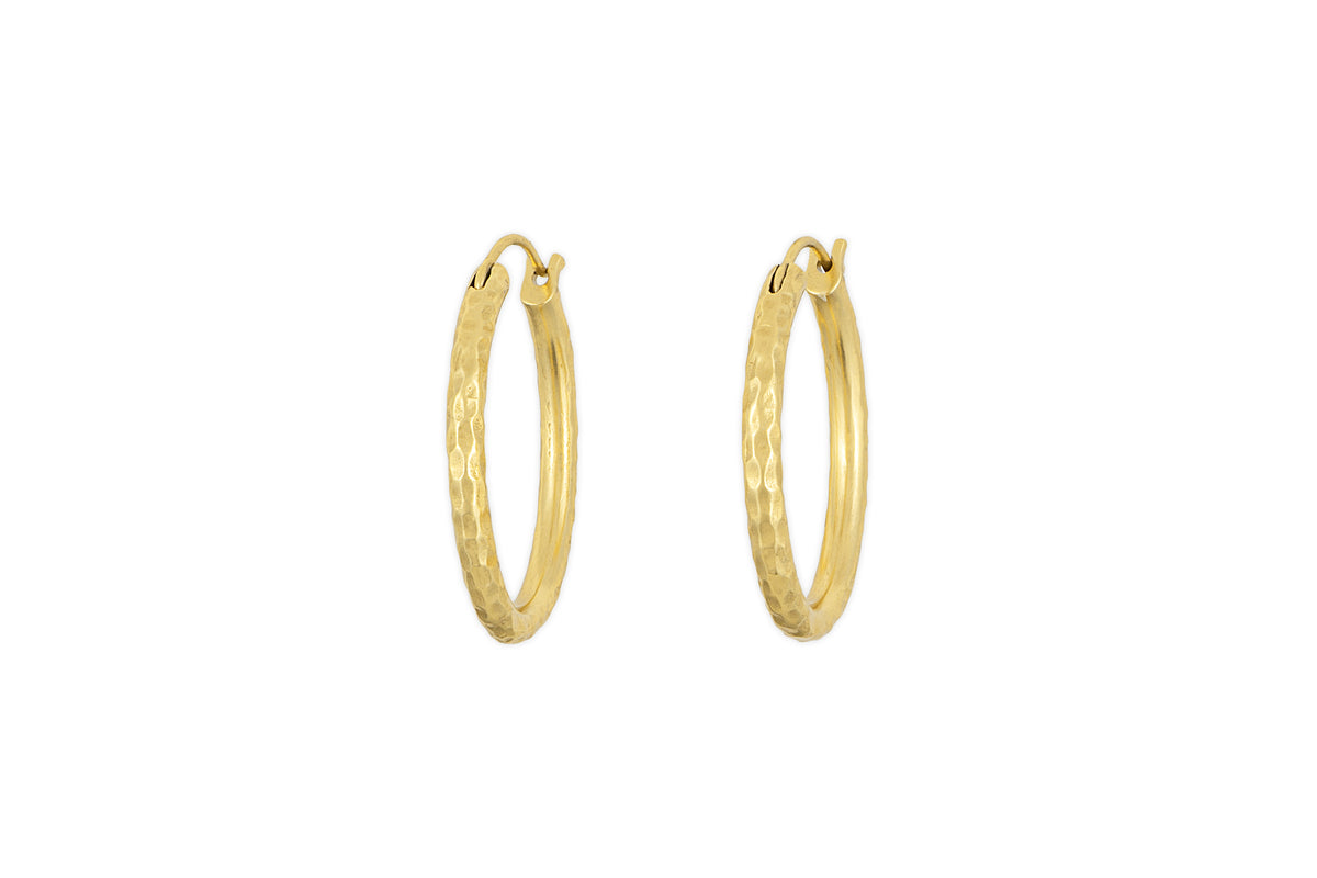 The Labani Earrings - Gold by nkuku feature a timeless hammered texture and are showcased against a white background.