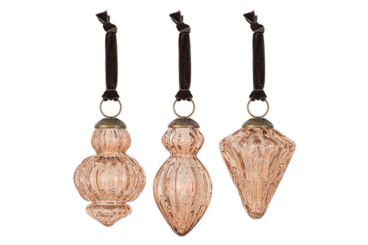 The nkuku Manipur Baubles - Copper (Set of 3) feature vintage-style glass ornaments with unique geometric shapes, intricate embossed designs, antique brass caps, and black velvet ribbons—ideal for festive or vintage Christmas decor.