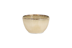 The nkuku Malia Breakfast Bowl - Cream features a ribbed texture, organic shape, and slightly uneven glossy rim with reactive glaze, shown here against a white background.